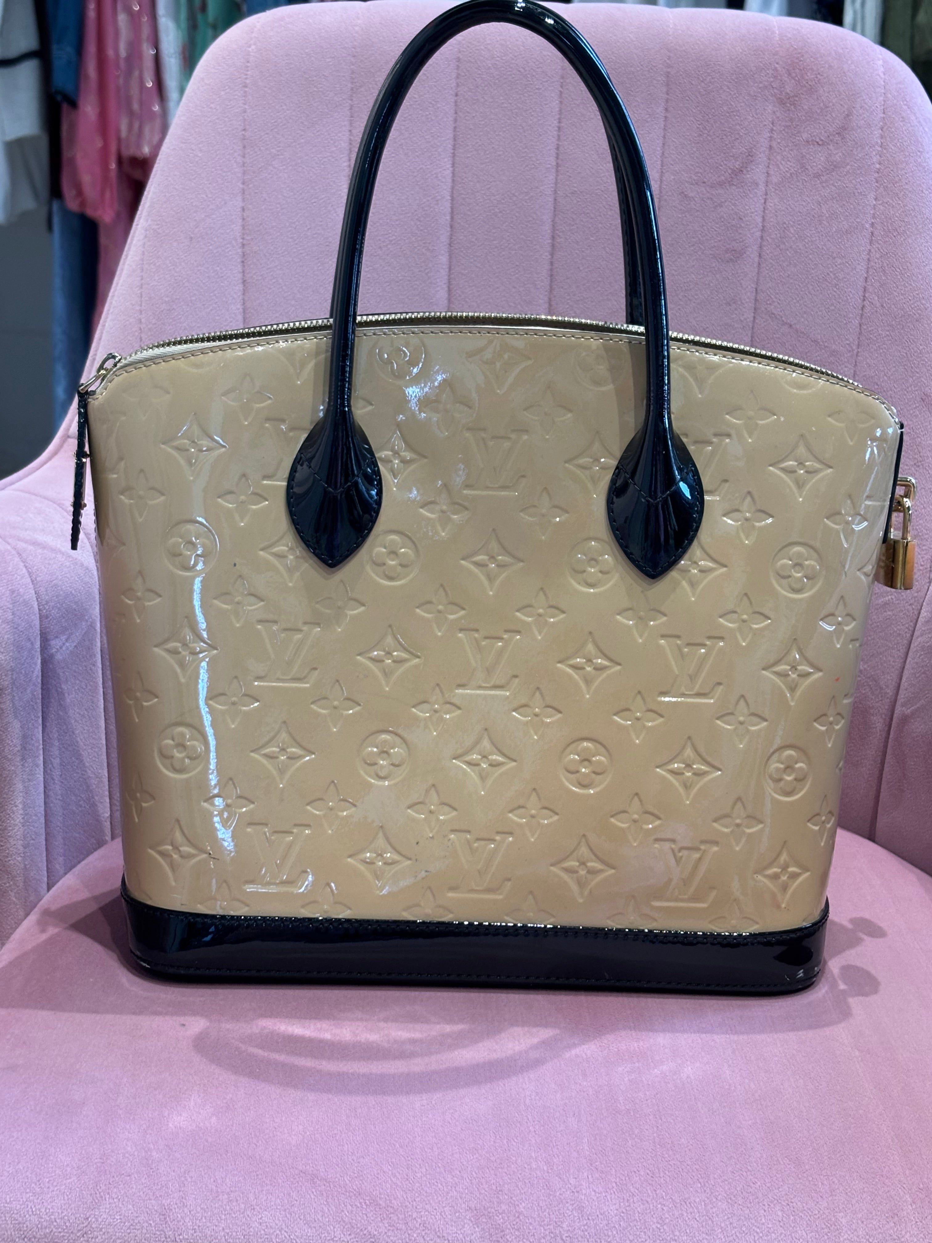 Beige patent leather with black patent leather handles and trim.
